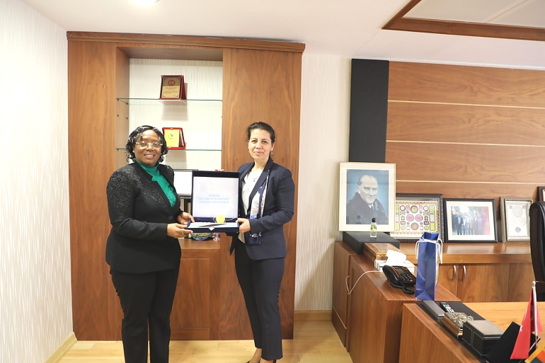 Ambassador Kiondo handing a Tanzania map to the General Manager of BETA Tea company Ms Ersoz at their Headquarters in Adana.